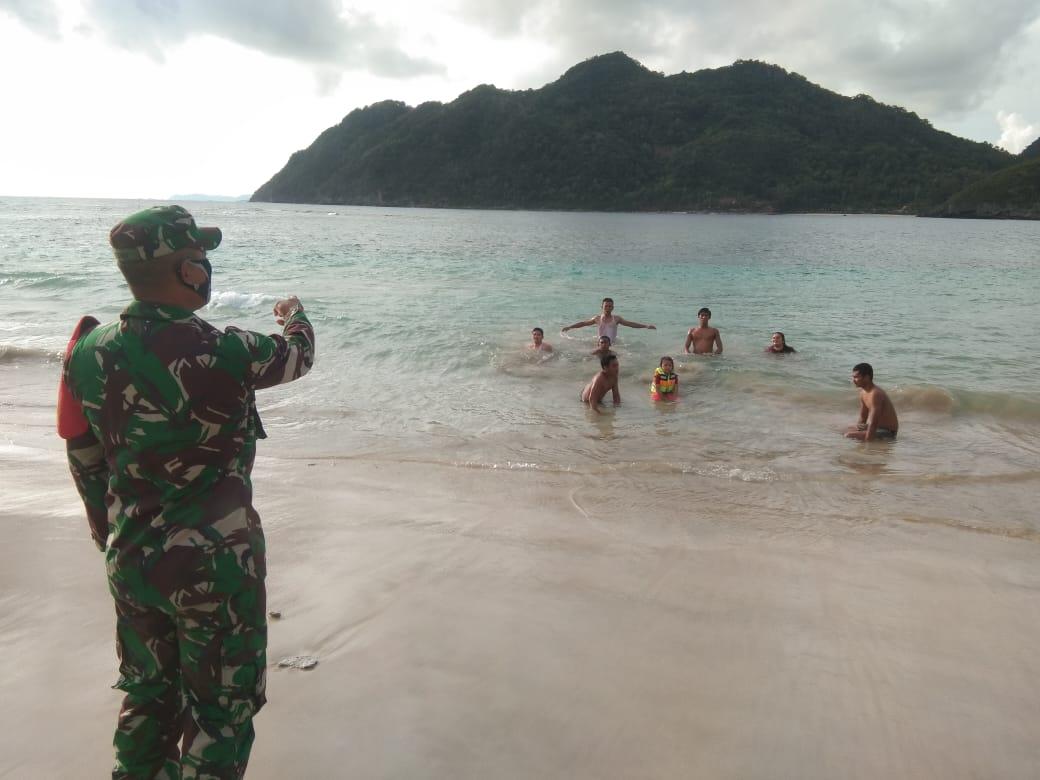 Babinsa Koramil 03/Lhoknga Himbau Pengunjung Pantai Tetap Waspada 