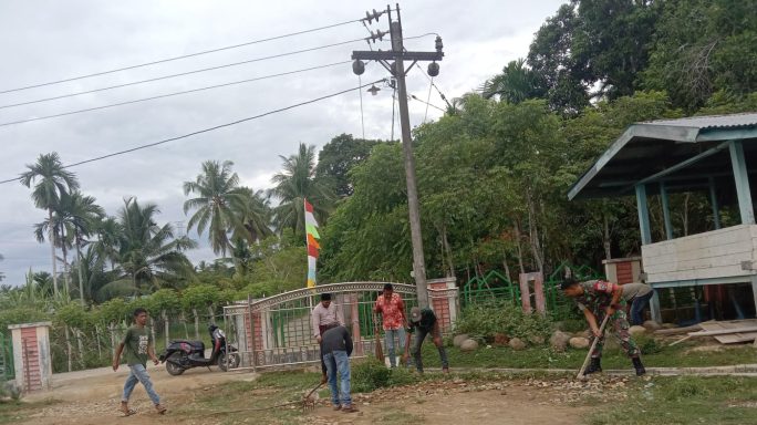 Koptu Fadli Hanggara Gotong Royong Bersama Warga Bersihkan rumput Dan Parit di Halaman Meunasah