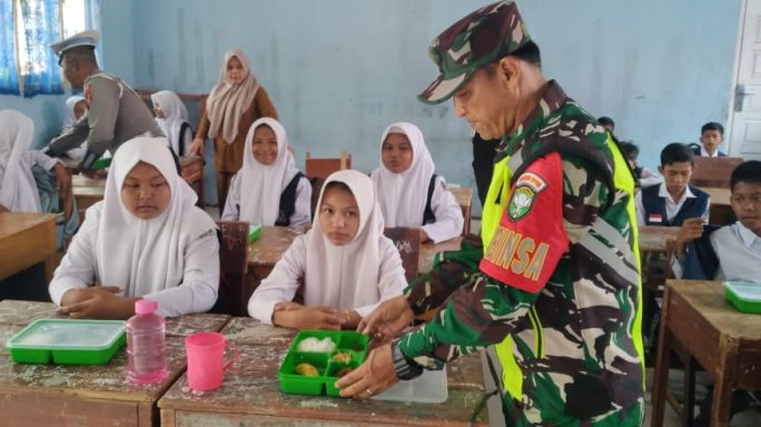 Babinsa Bantu Penyaluran Makan Bergizi Gratis Kesekolah sekolah Di Kecamatan Seunagan
